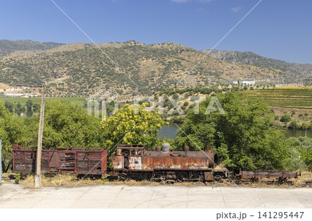 Abandoned rusty train on historic track by Douro river in Vila Nova de Foz Coa Abandoned rusty train on historic track by Douro river in Vila Nova de Foz Coa 141295447