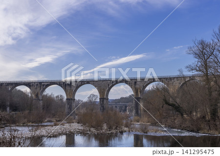 Old stone viaduct spanning river in Vogue, Ardeche 141295475