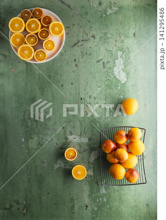 Fresh oranges and blood oranges on rustic green Fresh oranges and blood oranges on rustic green 141295486