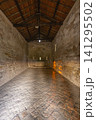 Ancient Romanesque chapel displaying stone walls and wooden roof Ancient Romanesque chapel displaying stone walls and wooden roof 141295502