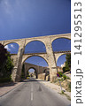 Los Arcos aqueduct arches spanning a road in Teruel Los Arcos aqueduct arches spanning a road in Teruel 141295513