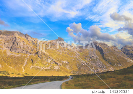 Driving a car on a mountain road in Lofoten islands, view from the windscreen. Norway, Europe 141295524