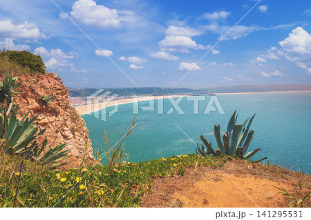Atlantic ocean, beach in Nazare. View from mount of Nazare city, Portugal, Europe Atlantic ocean, beach in Nazare. View from mount of Nazare city, Portugal, Europe 141295531