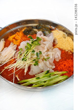 Korean cold raw fish soup Mulhoe with fresh seafood and spicy broth 141296556