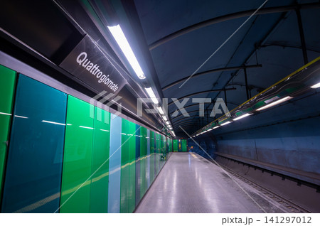 Naples, italy. December 28, 2024. Quattro giornate metro station platform featuring modern green and blue architectural design and bright fluorescent lighting in naples, italy Naples, italy. December 28, 2024. Quattro giornate metro station platform featuring modern green and blue architectural design and bright fluorescent lighting in naples, italy 141297012