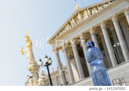 Plastic water bottle in front of the Austrian Parliament, symbolizing extreme summer temperature and rising heat impacts in Europe 141297081