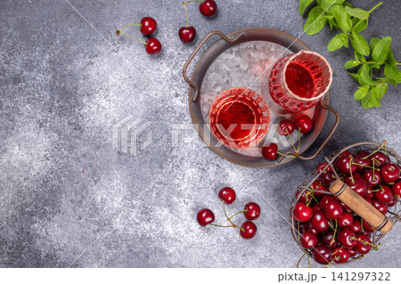 Cherry drink and fresh ripe cherries on rustic background Cherry drink and fresh ripe cherries on rustic background 141297322