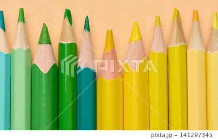 Multicolored wooden pencils in a row, drawing and creativity tools Multicolored wooden pencils in a row, drawing and creativity tools 141297345