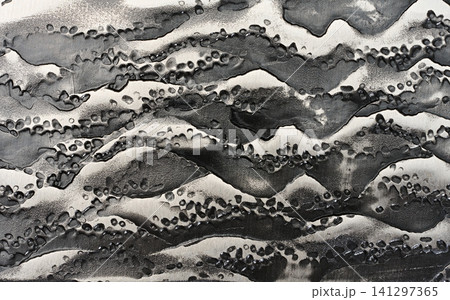 Close-up of the forged steel texture on a knife blade with a raised dark pattern. Close-up of the forged steel texture on a knife blade with a raised dark pattern. 141297365