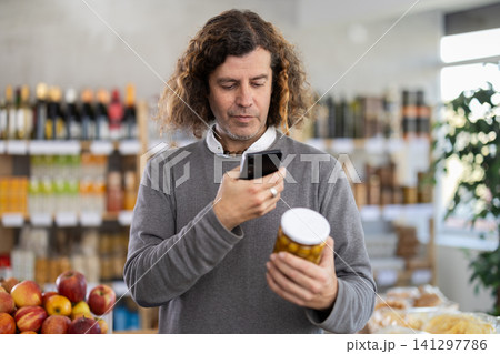 Adult man scanning qr code of olives 141297786