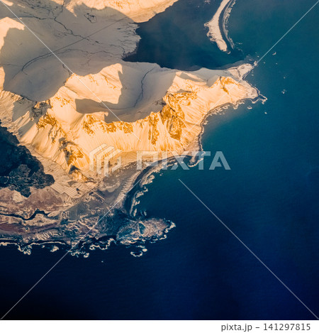 Aerial view of golden-lit snowy coastline in Hornafjordur, south Iceland Aerial view of golden-lit snowy coastline in Hornafjordur, south Iceland 141297815