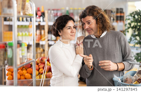 Husband and wife buying food in the supermarket Husband and wife buying food in the supermarket 141297845