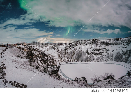 Northern lights above the snow-covered Kerid Crater and frozen lake in south Iceland Northern lights above the snow-covered Kerid Crater and frozen lake in south Iceland 141298105