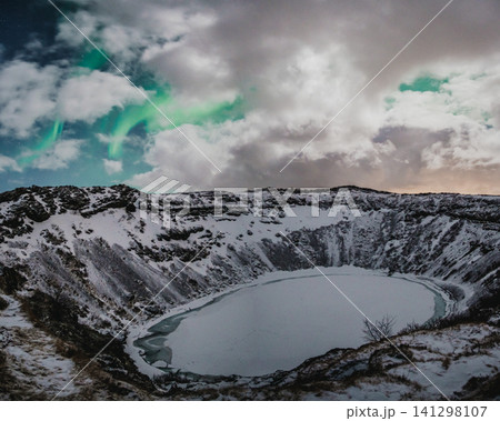 Northern lights above the snow-covered Kerid Crater and frozen lake in south Iceland Northern lights above the snow-covered Kerid Crater and frozen lake in south Iceland 141298107