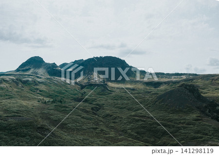 Rugged green hills and volcanic mountains in Thingvellir National Park, Iceland. 141298119