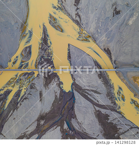 Aerial view of braided glacial rivers and a bridge in Hornafjordur, south Iceland. Aerial view of braided glacial rivers and a bridge in Hornafjordur, south Iceland. 141298128