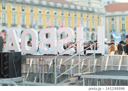 Crowd at a public event in Lisbon with large letters spelling out the city name and stage setup Crowd at a public event in Lisbon with large letters spelling out the city name and stage setup 141298996