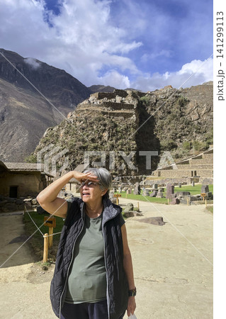 Tourist looking at Ollantaytambo archaeological ruins 141299113