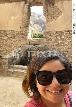 Woman at ancient Inca water temple ruins. UGC 141299114