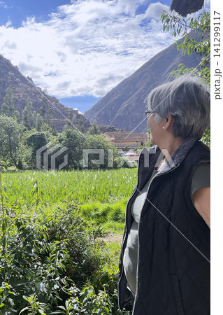 Woman standing by ancient Inca irrigation canal 141299117