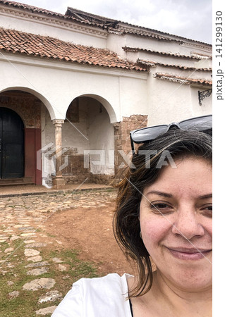 Woman in front of Chinchero colonial church. UGC 141299130
