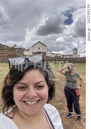 Women posing at Chinchero archaeological site park 141299134