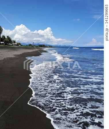 Ocean waves on a deserted beach with black volcanic sand. Ocean waves on a deserted beach with black volcanic sand. 141299663