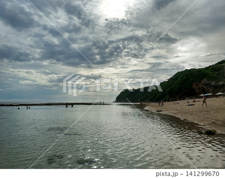 Panoramic views of the incredibly beautiful ocean. Clear turquoise water behind a reef on a deserted beach on the tropical island of Bali. 141299670