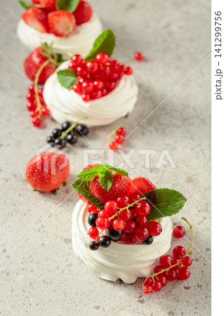 Pavlova dessert with strawberries, black currant, red currant, and mint. Pavlova dessert with strawberries, black currant, red currant, and mint. 141299756