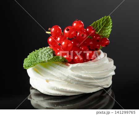 Pavlova dessert with red currant and mint. 141299765
