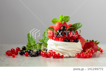 Pavlova dessert with strawberries, black currant, red currant, and mint. Pavlova dessert with strawberries, black currant, red currant, and mint. 141299772