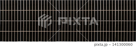 Vertical black finger tiles wall with light beige grout lines texture Vertical black finger tiles wall with light beige grout lines texture 141300060