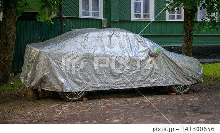 Silver car cover shields vehicle from elements Silver car cover shields vehicle from elements 141300656