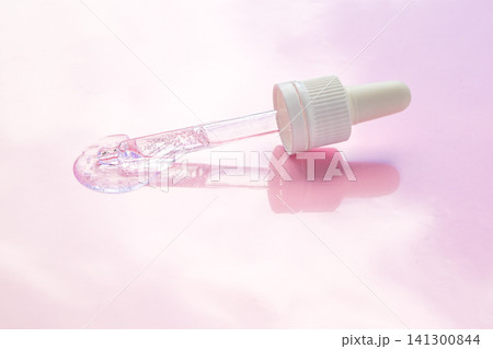 Skincare serum dropper with clear gel on pink background for beauty and cosmetic product photography 141300844