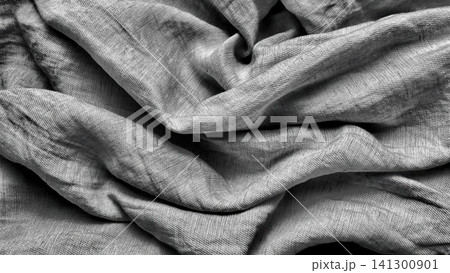 textured silver grey raw silk fabric drapery casting elegant shadows in a dramatic overhead high contrast macro shot 141300901