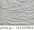 organic wrinkled white linen fabric texture with deep creases for sustainable packaging and minimalist web design 141300964