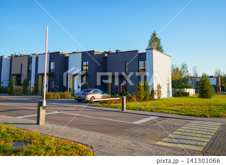 Automatic car barrier in Private urbanization residential area. Townhouses in Gated community Automatic car barrier in Private urbanization residential area. Townhouses in Gated community 141301066
