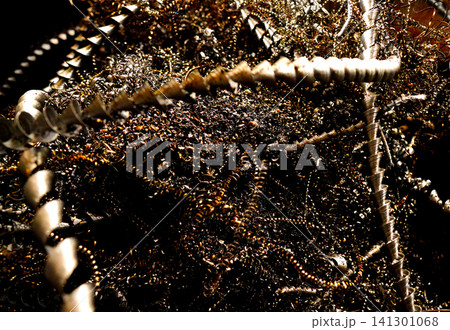 Steel scrap background. Metal chip waste after machining metal parts on cnc lathe Steel scrap background. Metal chip waste after machining metal parts on cnc lathe 141301068