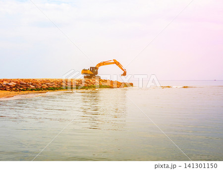 Breakwater construction at coastal. Beach regeneration on sea coastline. Breakwater construction at coastal. Beach regeneration on sea coastline. 141301150