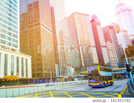City traffic in Central Business District of Hong Kong. Red taxis and double-decker buses on road City traffic in Central Business District of Hong Kong. Red taxis and double-decker buses on road 141301192