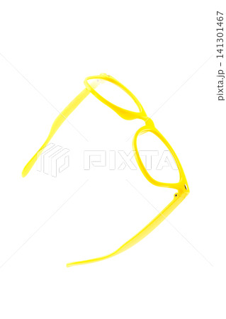 glasses plastic yellow without lenses lie half turned on an isolated white background glasses plastic yellow without lenses lie half turned on an isolated white background 141301467