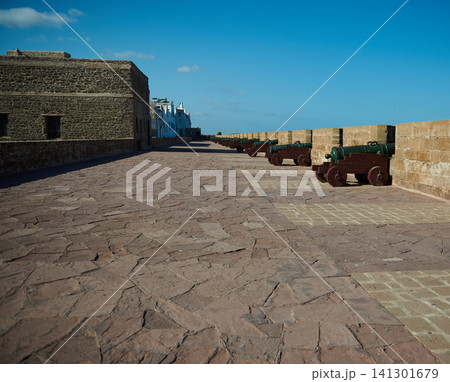 Cannons along the rampart in Essaouira old Medina overlooking the Atlantic on a clear day Cannons along the rampart in Essaouira old Medina overlooking the Atlantic on a clear day 141301679