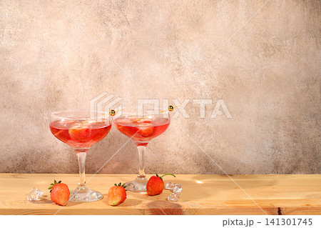 Refreshing summer lemonade cocktail, a mojito with strawberries, and iced soda, perfect summer party concept,bright, sunny summer banner serves as a menu promotion for a caf or bar.Modern still life Refreshing summer lemonade cocktail, a mojito with strawberries, and iced soda, perfect summer party concept,bright, sunny summer banner serves as a menu promotion for a caf or bar.Modern still life 141301745