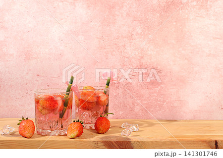 Festive alcoholic cocktail, pink martini in glasses on a bright background with strawberries, summer bar concept, alcoholic drinks at a party, restaurant and cafe advertising, modern still life Festive alcoholic cocktail, pink martini in glasses on a bright background with strawberries, summer bar concept, alcoholic drinks at a party, restaurant and cafe advertising, modern still life 141301746