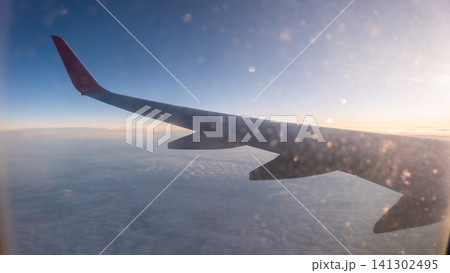 View on sunset and airplane wing from the inside View on sunset and airplane wing from the inside 141302495