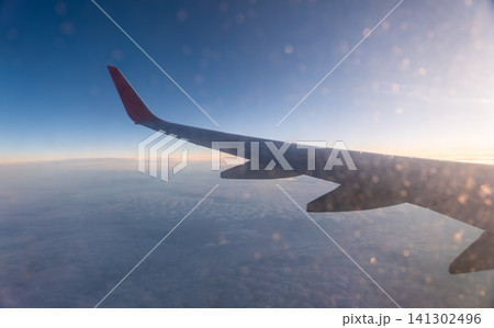 Beautiful salmon dawn and the wing of an airplane above the clouds. Beautiful salmon dawn and the wing of an airplane above the clouds. 141302496