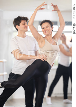 Young guy and adult woman rehearsing pair ballet Young guy and adult woman rehearsing pair ballet 141303807