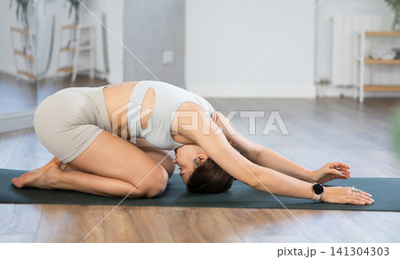 Young woman practicing hatha yoga in studio Young woman practicing hatha yoga in studio 141304303