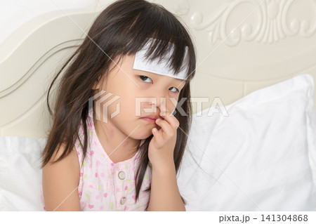 Unwell Asian Little Girl Feeling Discomfort and Touching Face Unwell Asian Little Girl Feeling Discomfort and Touching Face 141304868