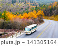 Bus Driving on Winding Road Through Autumn Forest for Nature Concept, travel agencies, tourism campaigns, transportation services, road trip promotion, educational materials, environmental publication 141305164